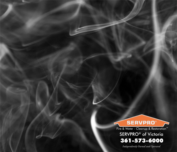 black background with smoke and SERVPRO victoria logo