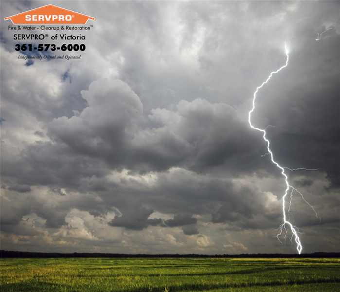Dark clouds with big lightning strike on the right hand side.  SERVPRO of Victoria logo on the left with company information.